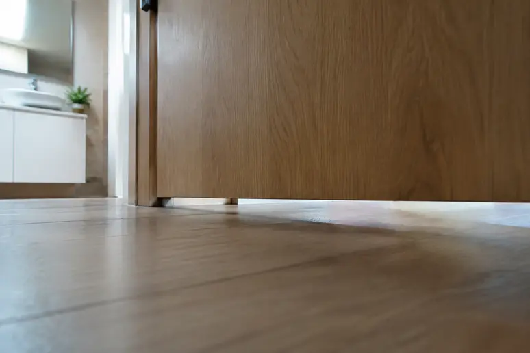 Espace de détalonnage sous la porte d'une salle de bain pour la circulation de l'air